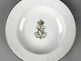 an image of a white plate with a gold rim and a crown on it