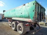 a green truck that is parked on the side of the road