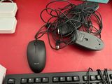 a computer keyboard and a mouse on a red desk
