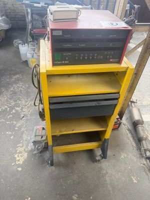 a yellow cart that has some tools on top of it