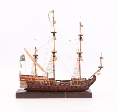 une maquette en bois d'un bateau pirate posée sur un socle