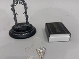 a book, a necklace, and a book sitting on a table