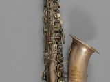 a saxophone hanging on the wall next to a wall