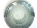a glass ball that is sitting on a white surface