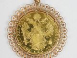 an image of a gold coin in a filigree setting
