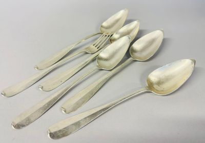 six silver spoons and two silver spoons sitting on a table