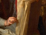portrait of a woman reading a book in a chair by a mirror