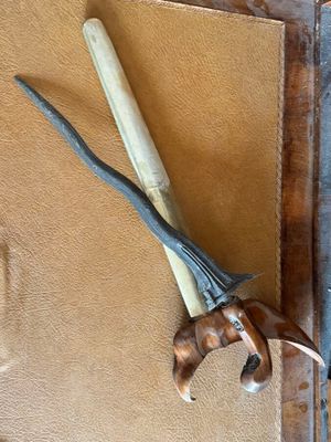 a knife and a pair of scissors hanging on a wall