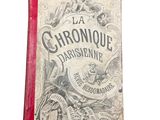 an old book with a red cover sitting on top of a white surface