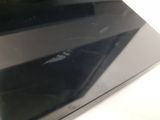 a close up of a black tablet computer on a white surface