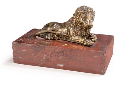 statue d'un lion posée sur un bloc de marbre rouge