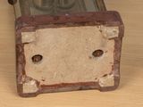 an old clock that is sitting on a wooden table