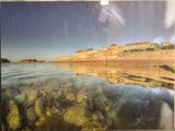 une photo d'une photo d'un lac avec des rochers dedans