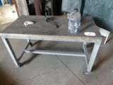 a table with a bottle of water and a pair of scissors on it