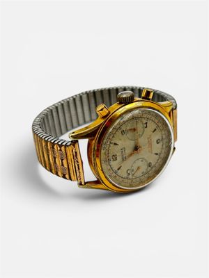 a close up of a wrist watch on a white surface