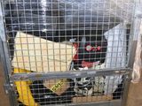 a metal cage with a bunch of clothes inside of it