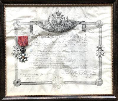 un vieux document orné d'un ruban rouge et d'une médaille