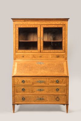 an antique oak bureau with glass doors and drawers