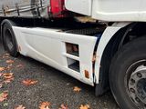 a semi truck that is parked on the side of the road