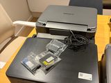 a printer sitting on a table next to a printer