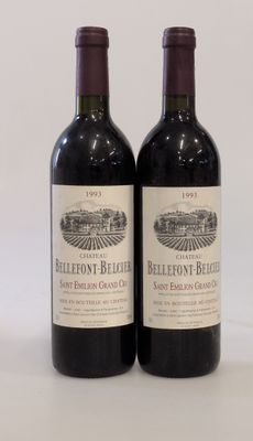 two bottles of red wine sitting next to each other on a table