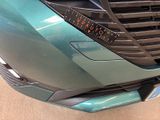 a close up of a car ' s grille with a clock on it