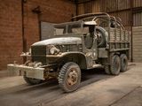 an old military truck parked in a garage