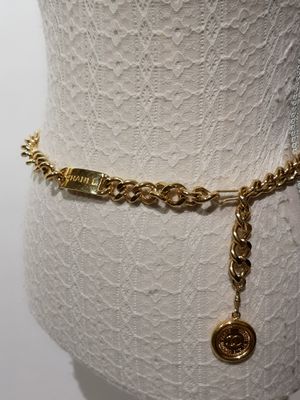 a close up of a mannequin torso with a chain around it