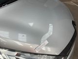 a white car that has a sticker on the hood of it