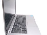 a silver laptop with a black keyboard on a white surface