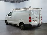 a white van parked in a room with a ladder on the roof