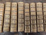 several old books stacked on top of each other on a table