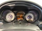 a close up of a car dashboard with three gauges on it