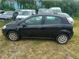 a black car that is parked in the grass