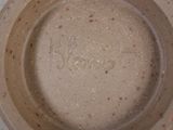 a close up of a brown bowl with writing on it
