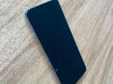an iphone is laying on a wooden surface with a broken screen