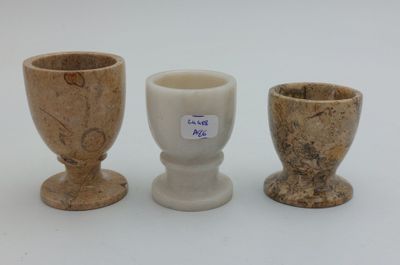 three small vases sitting next to each other on a table
