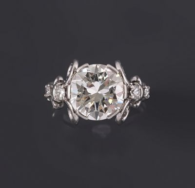 a diamond ring with three diamonds on a black background