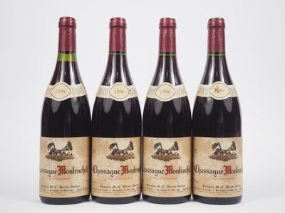 three bottles of wine are lined up on a white surface