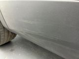 a close up of a car ' s front bumper and tire