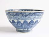 a blue and white bowl sitting on a white surface