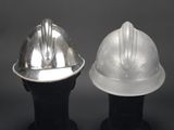 two silver hard hats sitting on top of each other