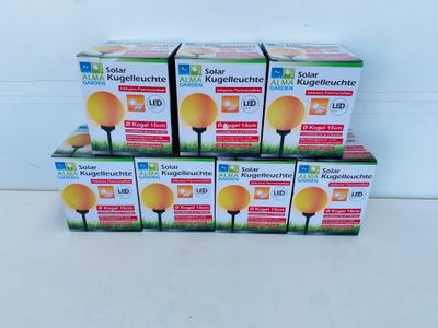 four boxes of bright yellow light bulbs sitting on a white surface