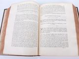 an open book on a table with a white background
