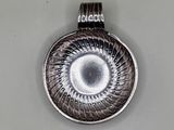 silver plated pendant with a spiral design on the front of it