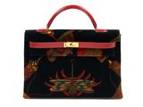 a black and red handbag with a red handle