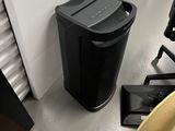 a black trash can and a brown trash can on the floor