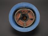 a blue bowl with a brown object inside of it
