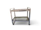 a metal trolley with two trays on wheels on a white surface