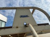 a close up view of a metal railing with a sign on it